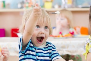 Kind freut sich über sein Essen in der Kita